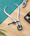 Built Tough Carbon Steel Caliper Kit For Hella Accurate Woodturning open on a cutting mat for precise measurements.