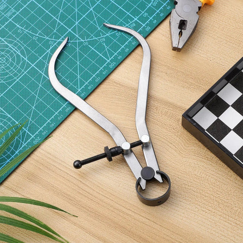 Built Tough Carbon Steel Caliper Kit For Hella Accurate Woodturning open on a cutting mat for precise measurements.