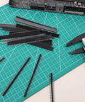 30 Piece 2.54mm 40 Pin Male And Female Header Pins Set on green cutting mat with PCB in background