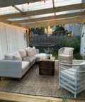 Outdoor space with Plug In Crystal Swag Chandelier With Three Lights, wicker furniture, and ambient lighting under a pergola.