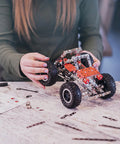 Hands building a car model from Beast Mode Erector Set Metal Model Kit For Adults Teens And Advanced Kids Build Cars Planes And Excavators