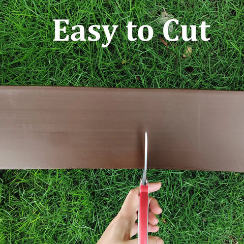 DIY Friendly 20Ft Plastic Garden Edging Kit With 25 Stakes Four Point Five Inch Tall Lawn Border being cut with scissors