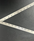 Heavy Duty Three Quarters Inch By Two Foot Steel Rule For Shop And Insulation Work Blacksmith Ruler with Precise Measurements on black surface.