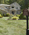Hillsborough Heavy Duty Copper Post Mounted Mailbox For Outdoor Use With Rust Resistant Steel Construction in front of house