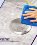 Hand wiping a 6-inch Round Pop-Up Floor Box Kit with 20A Tamper-Resistant USB Receptacle on marble surface