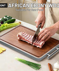 Cutting raw meat on Two In One Titanium And Ebony Wood Cutting Board With Handle And Juice Groove, double sided for meat and charcuterie.
