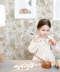 Girl painting in room with Kid Friendly Peel And Stick Wallpaper With Boho Woodland Forest Vibe For Cabinets And Nursery Walls Removable Self Adhesive Decor For Bedroom Cute Animal Theme 393 Inches Long By Seventeen Point Three Inches Wide.
