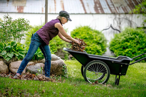Person using Beefy Heavy Duty Utility Cart With 10 Cubic Feet Tub And 400 Pound Load Capacity With Flat Free Wheels in yard