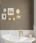 Bathroom wall featuring Taupe Grasscloth Wallpaper Peel And Stick 32 Inch Wide By 354 Inch Long Roll Self Adhesive Textured Faux Grasscloth Contact Paper For Cabinets Walls And Furniture With Easy Install 78.46 Sq Ft Coverage No Mess Removable with framed art above a white bathtub.