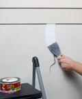 Heavy Duty Rubberized Waterproof Sealant Paste In Bright White Half Quart Tub applied with a putty knife on a wall seam.