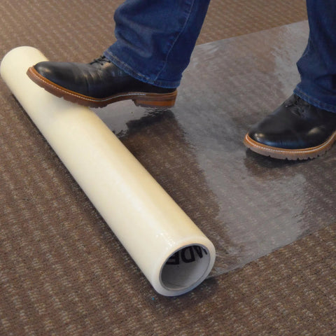 Carpet Protection Film 36 Inch By 500 Foot Floor And Surface Shield With Sticky Backing being rolled out on carpet