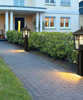 Dusk To Dawn Post Mount Outdoor Light Head With Seeded Glass illuminating a garden pathway at dusk, weather-resistant build