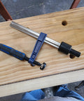 Quick-Adjust Vertical Workbench Hold Down Clamp For Three Quarter Inch Dog Holes with 1.5-inch serrated post on wooden bench