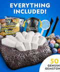 Gigantic Gemstone Dig Kit For Kids Fun Excavate 50 Real Gems From A Giant Dig Brick With Tools, bag, and colorful gemstones shown