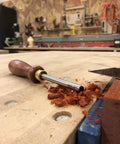 Pro Grade Cabinet Scraper Burnisher Tool With Hard Maple Handle And Super Hard High Speed Steel Rod on a woodworking bench