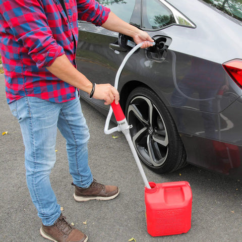 Person using Battery Powered Fuel Transfer Pump With Auto Stop for gas transfer with extra long hose and suction tube, portable at 2.4 GPM