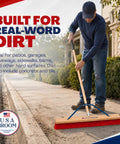 Heavy Duty 36 Inch Commercial Push Broom With Extended Handle For Hassle Free Indoor Outdoor Sweeping Built Like A Tank Workshop Floor Sweeper All Stainless Hardware Real American Made Rig in use on outdoor pavement.