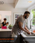Man washing hands in kitchen with LED BR30 Flood Light Bulb 65W Equivalent Energy Saving 9W Dimmable illuminating the room
