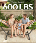 Family sitting on 600 Lb Hammock With Stand For Outdoor Or Indoor Use 2 To 3 Person Portable Hammock, brown and black.