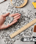 Hand holding 20 Lb Decorative Epoxy Floor Flake Kit For Garage And Concrete Surfaces Black White Gray Color Chips Blend