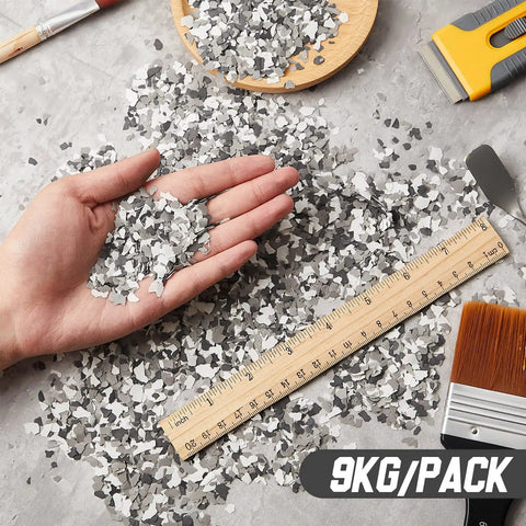 Hand holding 20 Lb Decorative Epoxy Floor Flake Kit For Garage And Concrete Surfaces Black White Gray Color Chips Blend