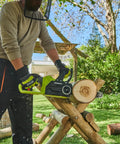 Hella Smooth 18V Brushless Battery Chainsaw With 30Cm Oregon Bar in use cutting log on wooden support outdoors.