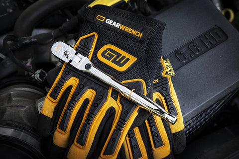 Quarter Inch Drive Locking Flex Head Ratchet with 60 Tooth Gear and Nine Position Push Button Lock on mechanic gloves engine bay
