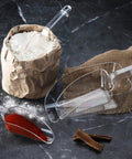Commercial Grade Polycarbonate Ice Scoop 24 Ounce Clear Utility Scoop For Ice Flour And Sugar In Busy Kitchens Real Kitchen Workhorse Break Resistant With Beveled Front Edge For Easy Scooping And Spill Prevention pictured with flour and spices