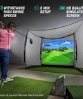 Man golfing indoors with Backyard Golf Practice Net Cage 10x8 Ft Enclosed Swing Zone With Side And Top Netting Impact Screen Included.