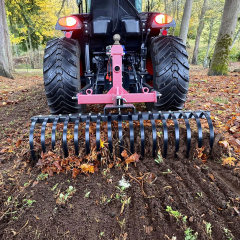 Tow Behind Landscape Rake with 48 Inch Working Width, 17 Steel Tines, 2 Inch Receiver attached to tractor removing leaves