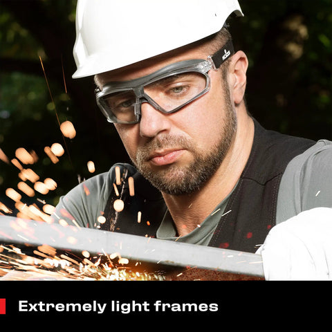 Man wearing Anti Fog Safety Goggles For Men And Women With Premium Coating while cutting metal, sparks flying, wearing hard hat
