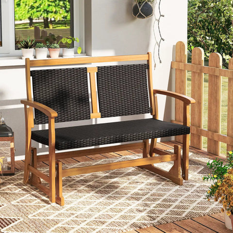 Two Person Wooden Outdoor Glider Bench With Acacia Wood Armrests And Wicker Back And Seat Rocking Patio Loveseat on porch