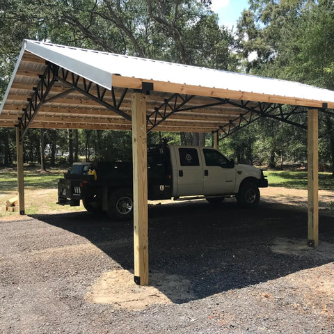 Carport with wooden posts anchored by Fence Post Holder Ground Spike for Concrete Deck, 4x4 Post Base Anchor, Steel Black Powder Coated, 4 Pack