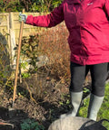 Gardener holding a Stainless Steel Long-Handled Trowel With An Ergonomic Grip For Effortless Digging And Back-Friendly Comfort In The Garden