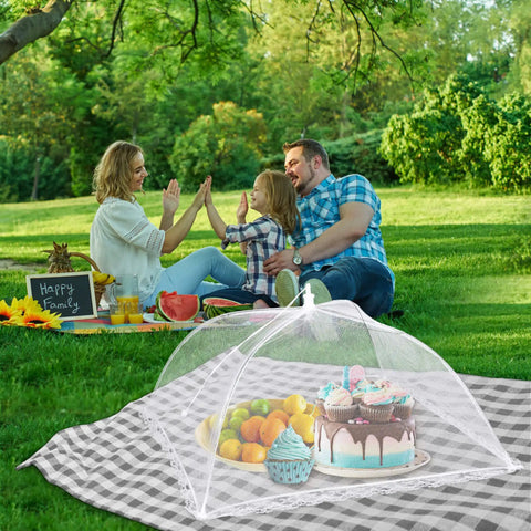 Outdoor Mesh Food Covers Set 10 Pack Pop Up Tents for Picnic and Camping covering food at a family picnic, keeps bugs off food.