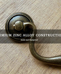 Vintage Bail Drawer Pull Set 4 Pack Antique Brass Cabinet Handles 3.75 Inch Center To Center For Dresser Cupboard Wardrobe And Kitchen Cabinets Classic Drop Design showing premium zinc alloy construction on wood surface.