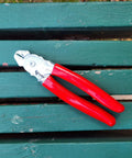 Heavy Duty Hog Ring Pliers With 3/8 Stainless Hog Rings Spring Loaded Jaws PVC Grips 7 Inch on green surface