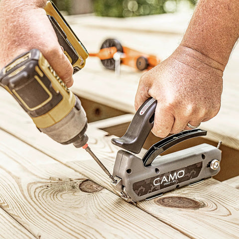 Edge Deck Screws For Hidden Fastening One And Seven Eighths Inch ProTech Coated 1750 Count Built For Pressure Treated Lumber Hardwood Cedar And Composite Decks Angled Installations being used with a drill on a wooden deck