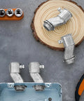 Four Pack Half Inch EMT To Box Offset Connectors With Set Screw And Lock Nut Conduit Fittings For Galvanized Steel Electrical EMT Conduit Zinc Die Cast displayed on wooden background with tools