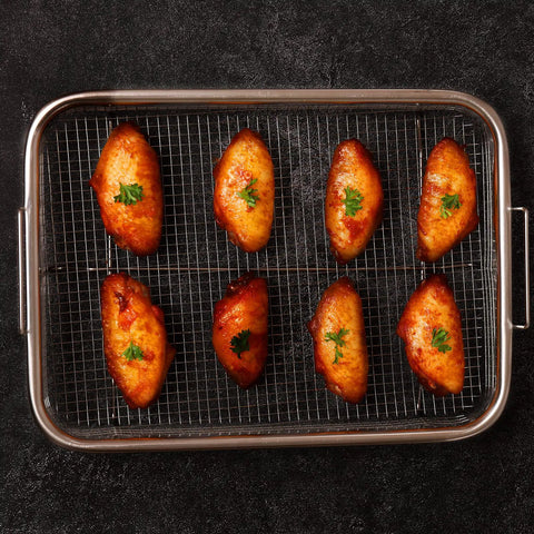Nonstick Mesh Air Fryer Basket Set For Oven with chicken pieces, stainless steel grill tray, 360 degree air circulation, top view