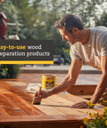 Man applying Australian Timber Oil Wood Stain And Protector Jarrah Brown Finish for decks and fences with deep penetration.