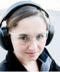 Person wearing Two Pack SonicSeal Hearing Protection Earmuffs for Shooting, Range, and Hunting, 31.5 dB SNR, with safety glasses.