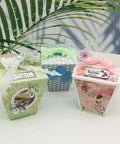 Colorful decorated gift boxes made with Milk Box Gift Box Die Cut Set For Paper Craft And Scrapbooking, featuring floral designs and ribbons.