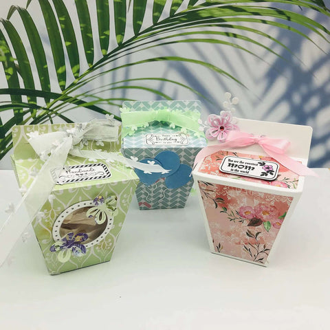 Colorful decorated gift boxes made with Milk Box Gift Box Die Cut Set For Paper Craft And Scrapbooking, featuring floral designs and ribbons.