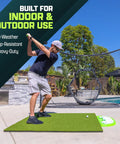 Man practicing swing on Elite 5 By 4 Foot Golf Hitting Mat With 15 Mm Artificial Turf for indoor outdoor use