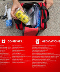 Open medium travel bag containing cat and dog first aid kit for home and travel with thermometer, bandages, antiseptic essentials.