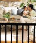 Family sitting in living room behind Deluxe Stair Gate For Pets And Kids, Super Easy Install No Fuss Secure Build, Black Wood