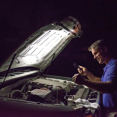 Man using Ultra Bright LED Flashlight With 5 Beam Modes, Adjustable Focus From Spotlight To Flood, Tactical Emergency Light under car hood