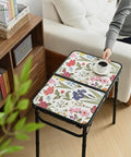 Small Camping Table With Vintage French Floral Pattern Folding Design Adjustable Height Lightweight Portable Picnic Table With Carry Handle For Patio Living Room And Travel shown in a living room setting with a coffee cup.