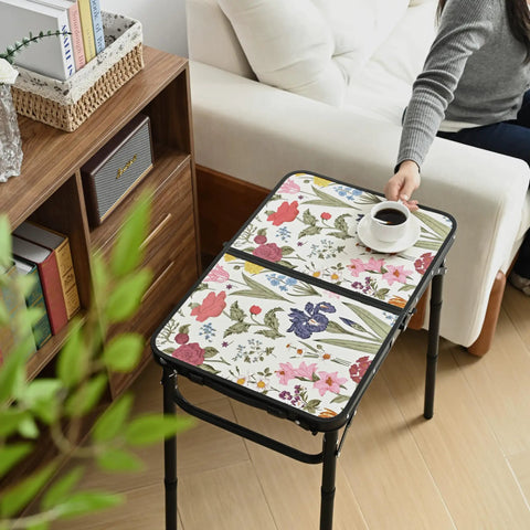 Small Camping Table With Vintage French Floral Pattern Folding Design Adjustable Height Lightweight Portable Picnic Table With Carry Handle For Patio Living Room And Travel shown in a living room setting with a coffee cup.